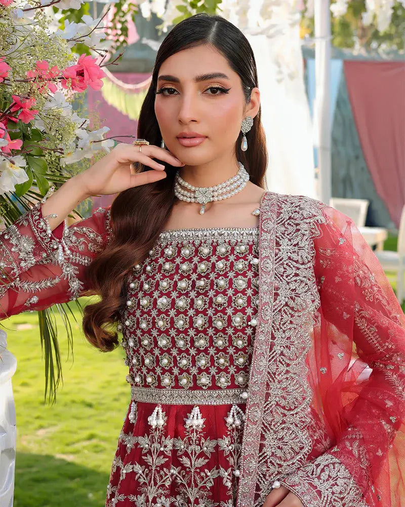 Close-up of AROOSH Wedding Wear bodice with pearl and sequin detailing on red organza, paired with embroidered net dupatta for party wear.