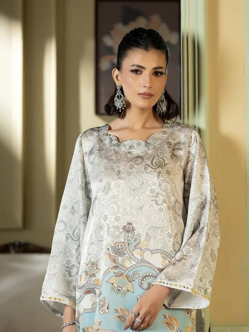 Close-up of woman in silk outfit with intricate embroidery and earrings