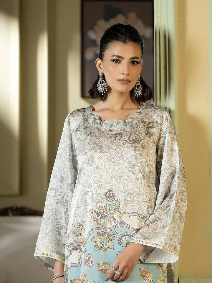 Close-up of woman in silk outfit with intricate embroidery and earrings