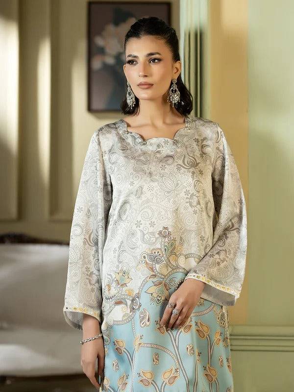 Woman in silk embroidered outfit with jewelry in a decorated room