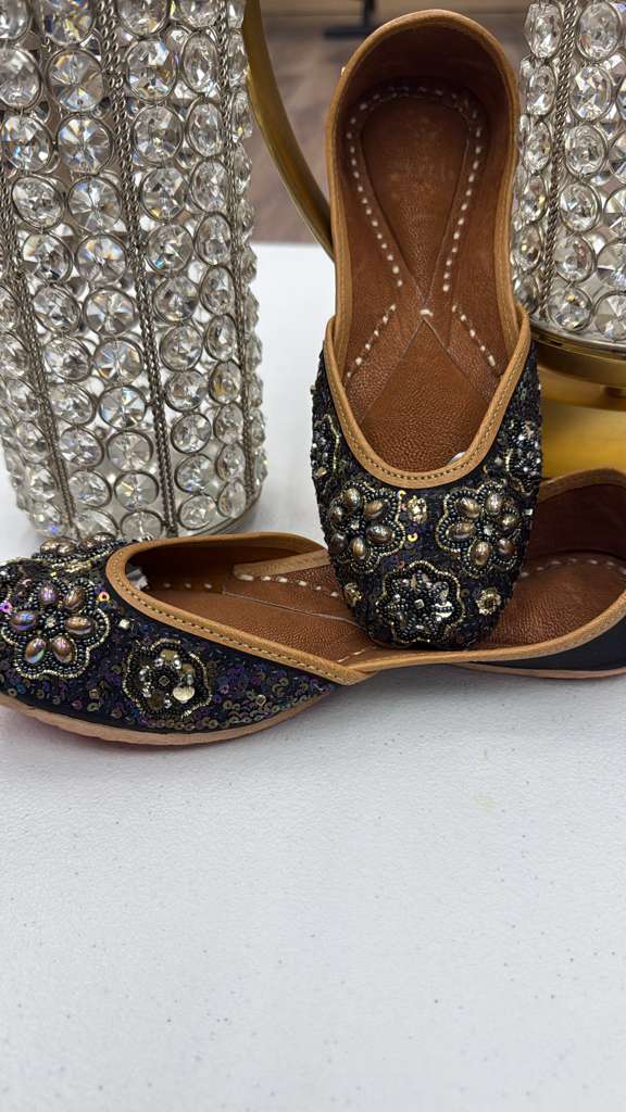Handcrafted Raqs Black Khussa flats featuring detailed embellishments, ideal for formal events and traditional celebrations.