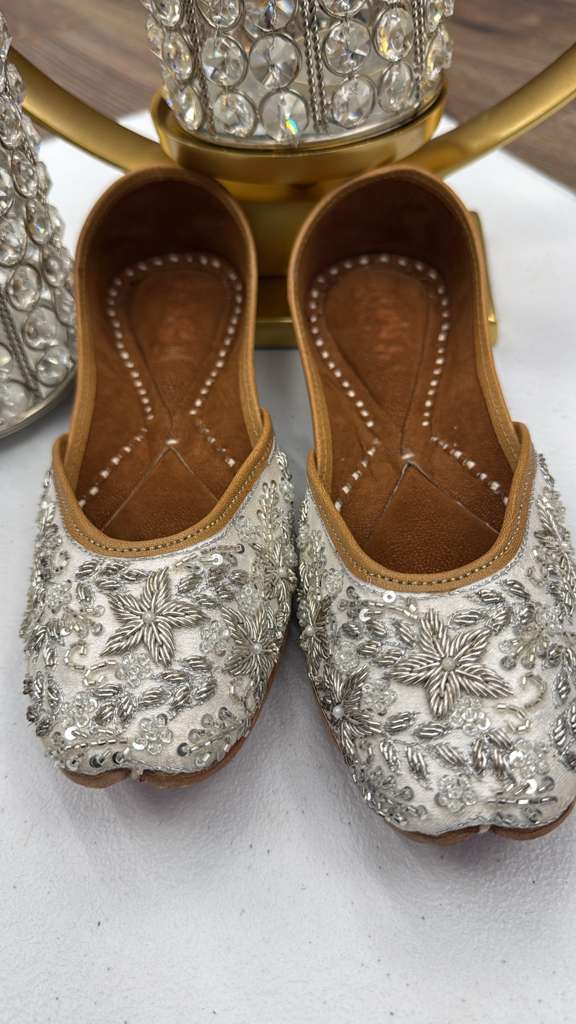 Close-up of Dabka Silver Jutti showcasing detailed hand embroidery and silver embellishments, ideal Khussa for Ladies in festive attire.
