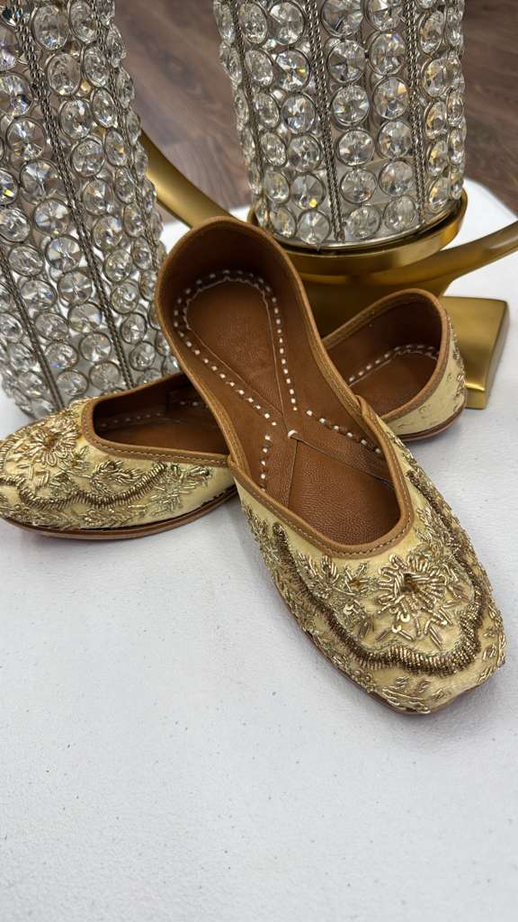 Shop Rawa Golden Jutti - Khussa Shoes with intricate zari metallic embroidery. Traditional flat footwear in muted gold for festive and ethnic wear.