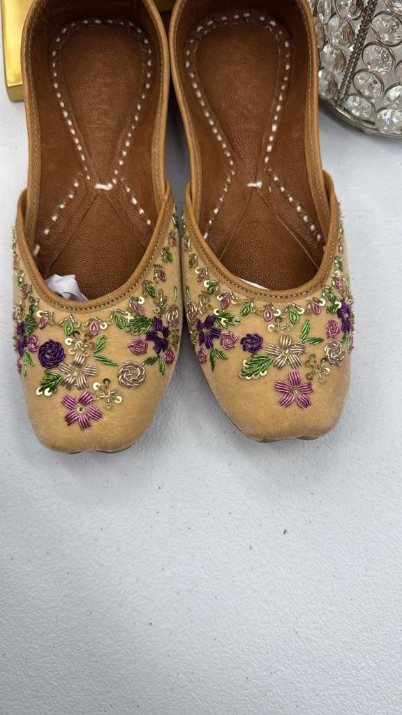Close-up of Shahi Yellow Jutti showing detailed tilla and thread embroidery on velvet, perfect for ethnic and formal wear.