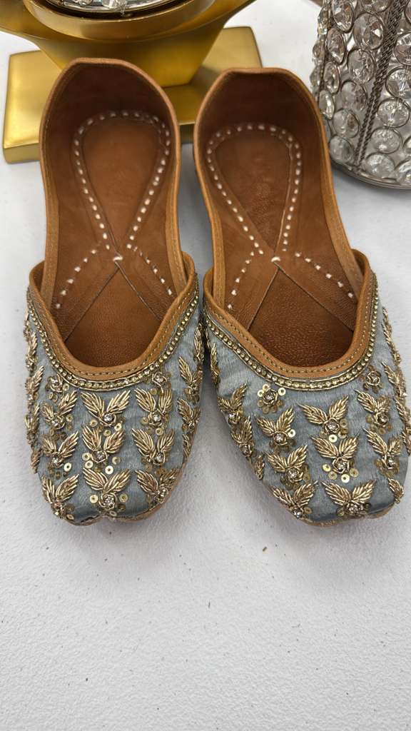Silver-grey Rani Grey Jutti with gold zari detailing and handcrafted sequin accents. Stylish Pakistani khussa shoes for festive and formal outfits.