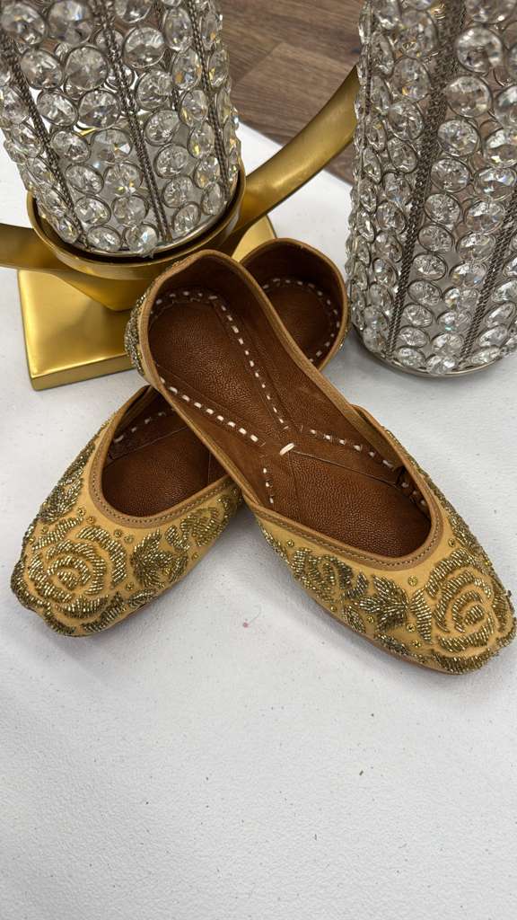 Zamurd Yellow Jutti - Khussa with intricate gold embroidery, featuring floral beadwork and brown leather lining for festive wear.