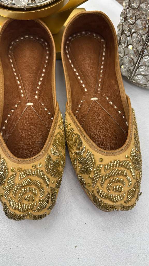 Close-up of Zamurd Yellow Jutti - Khussa showcasing gold embroidered roses and fine bead detailing on soft yellow fabric.