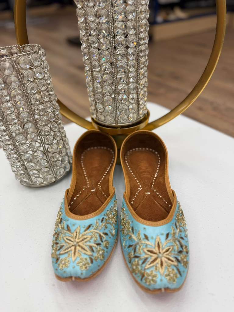 Traditional Bisma Light Blue Jutti featuring gold floral embroidery, ideal handcrafted flats for spring events and cultural occasions.