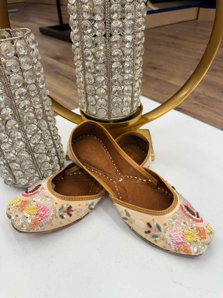Sundus Sequin Jutti - Khussa Mojari Shoes with intricate pearl and sequin embroidery, displayed elegantly against crystal decor.