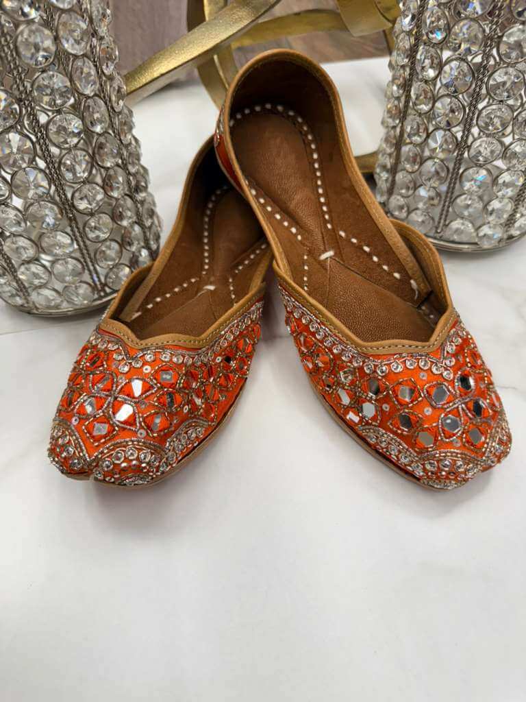 Sharmila Orange Jutti - Ladies Jutti with intricate mirror and beadwork, perfect for weddings and festive wear. Elegant flat footwear for women.