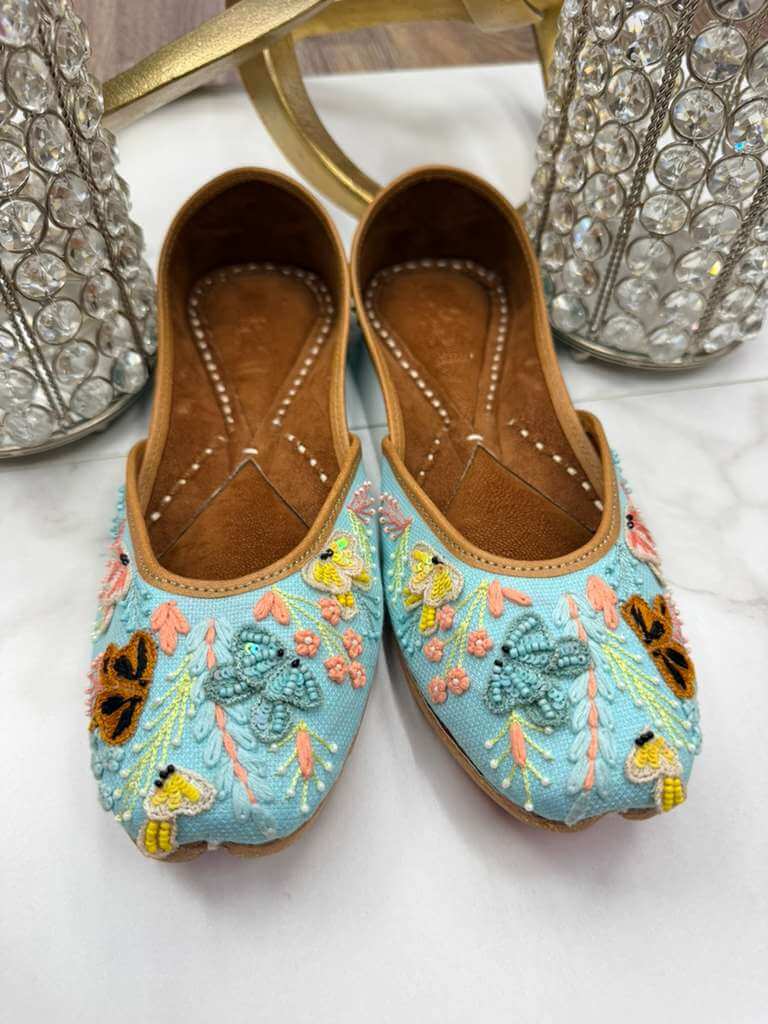 Front view of Sanjana Sky Blue Jutti - Ladies Shoe featuring intricate multicolor embroidery and chic handcrafted detailing.