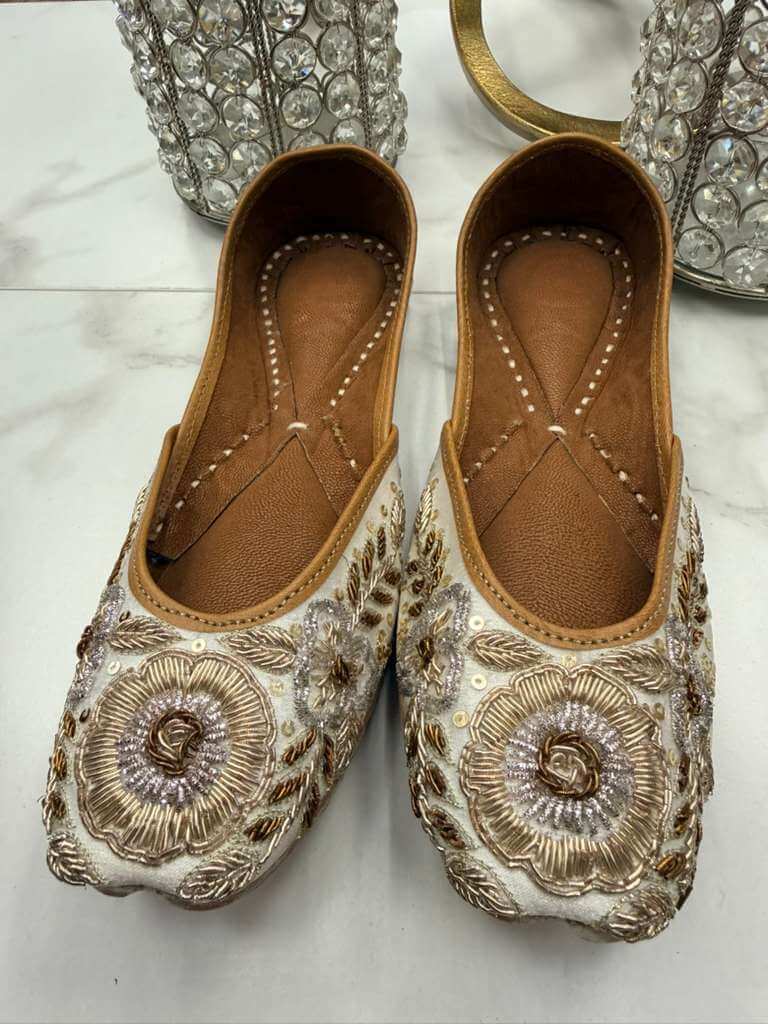 Elegant Shahzadi Off-white Jutti featuring dense hand embroidery with pearls and sequins, perfect for festive and ethnic outfits.
