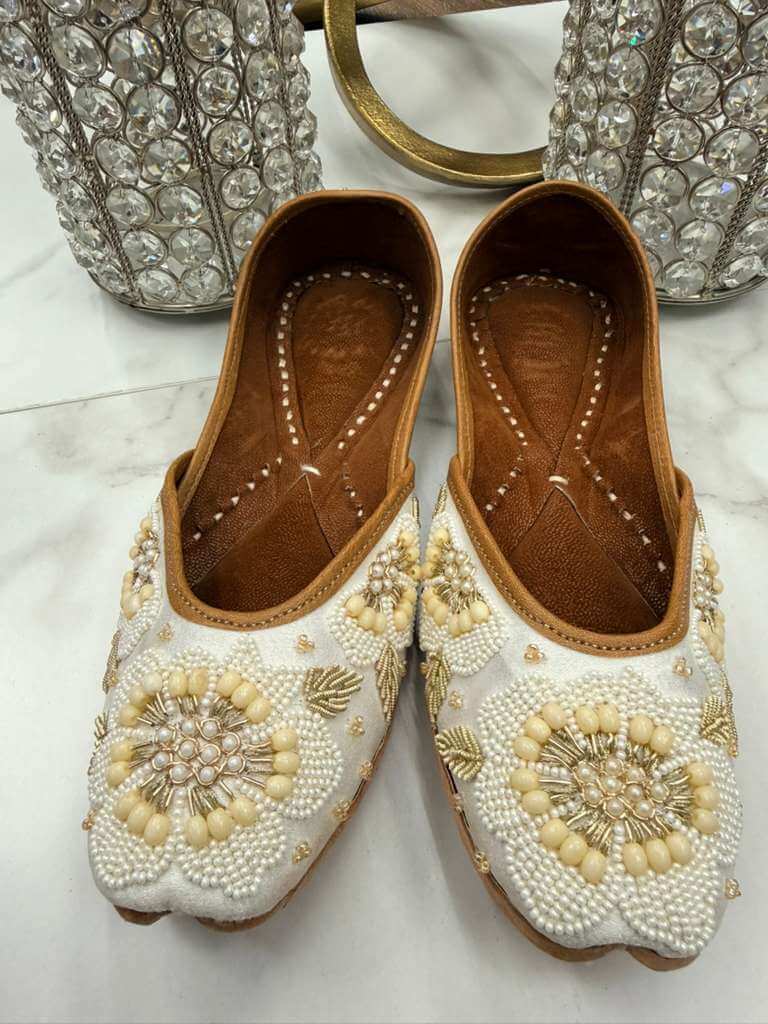 Elegant Sultana Off-white Jutti featuring detailed pearl embellishments and handcrafted design, perfect for ethnic and fusion outfits.