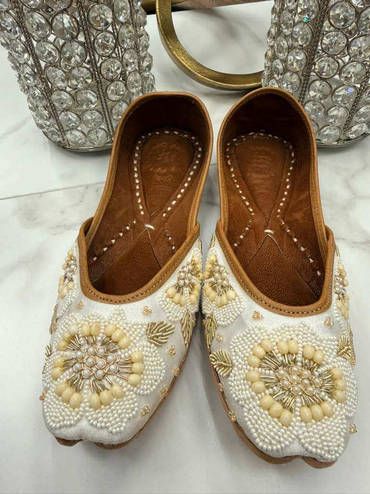 Elegant Sultana Off-white Jutti featuring detailed pearl embellishments and handcrafted design, perfect for ethnic and fusion outfits.