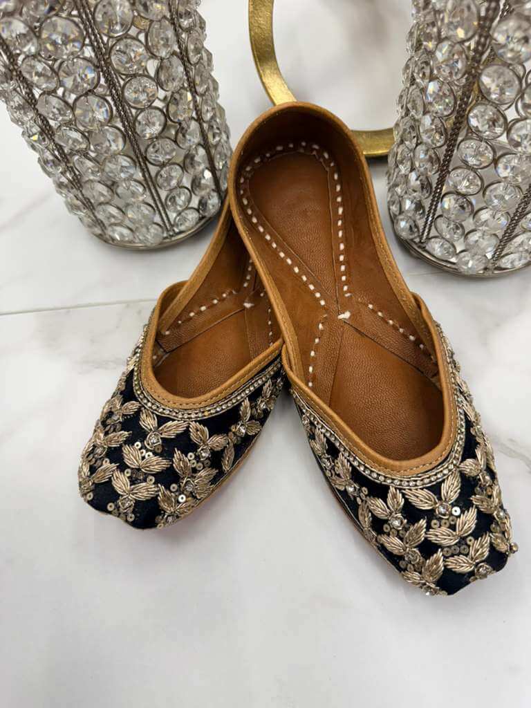 Priyanka Black Jutti - Woman Shoe | Timeless Elegance featuring gold thread embroidery on black fabric, ideal for traditional outfits.
