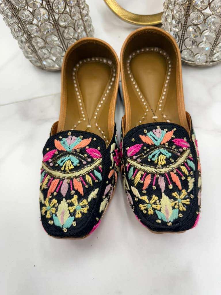 Elegant Maria Black Jutti featuring intricate embroidery and pearls, ideal for traditional outfits and special occasions.