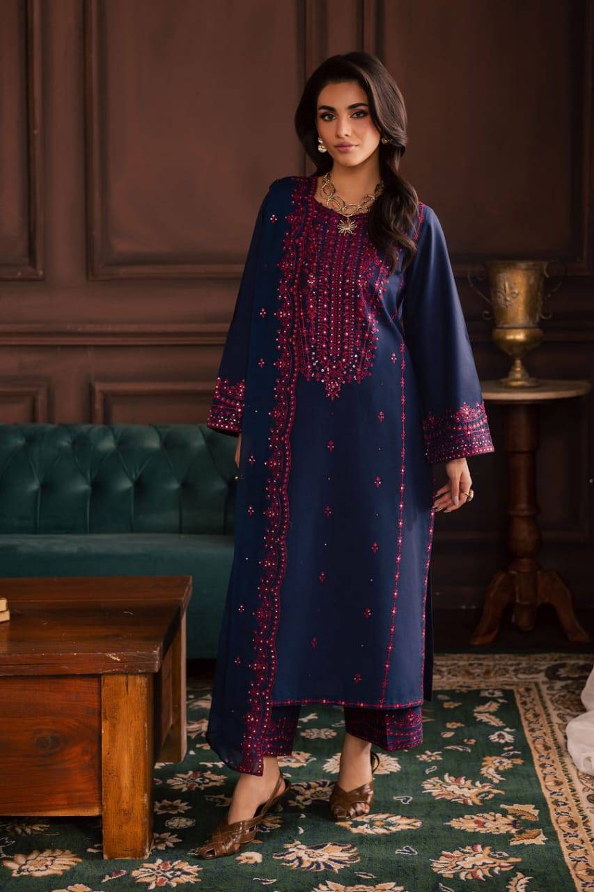 Model standing in BATIK Lamia 3Pc navy khaddar dress with vibrant pink embroidery, styled with traditional footwear for a complete winter look.