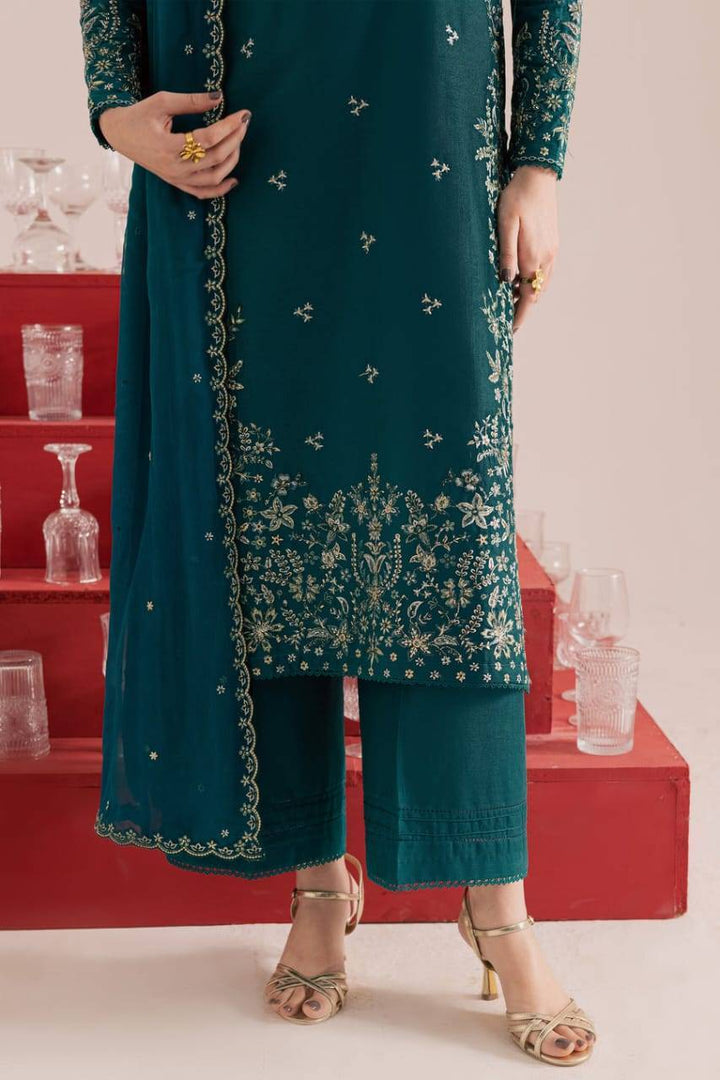 Lower half of BATIK Dark Forest 3Pc embroidered khaddar dress showing floral hem embroidery, wide-leg culottes, and gold heels for a festive look.