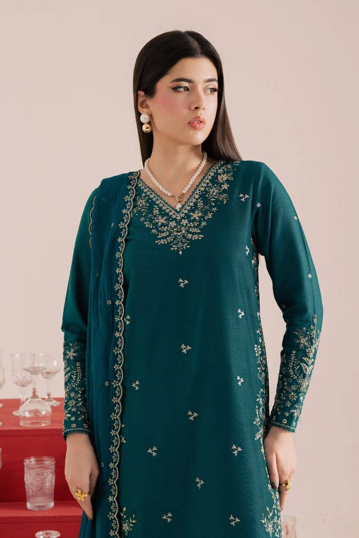 Detailed neckline and sleeve embroidery of BATIK Dark Forest 3Pc embroidered khaddar dress with pearl accessories and teal crinkle dupatta.