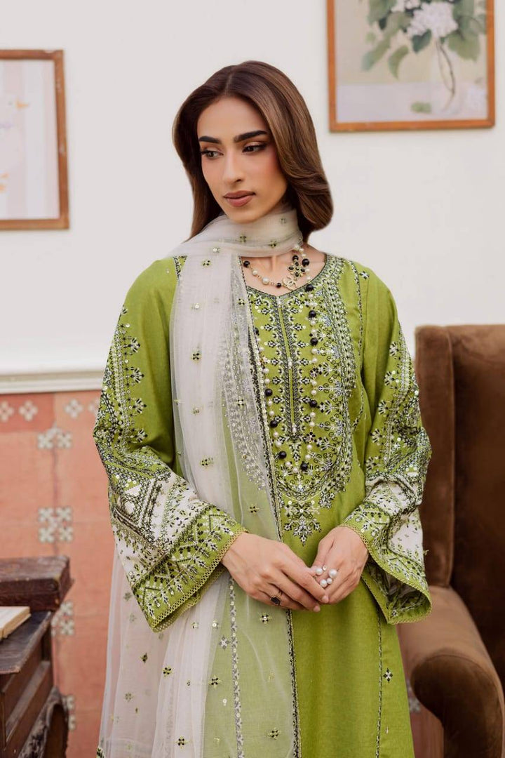 Close-up of BATIK WOMEN DRESS FOR EID 3-piece set featuring intricate embroidery on green karandi fabric with sheer white dupatta.