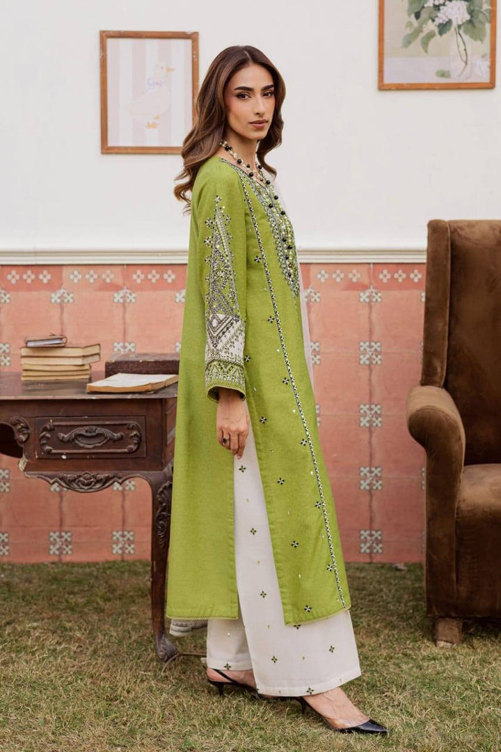 Side profile of BATIK WOMEN DRESS FOR EID 3-piece green karandi outfit with embroidered sleeves and white trousers.