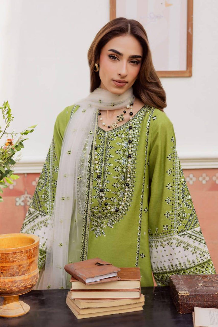Model wearing BATIK WOMEN DRESS FOR EID 3-piece green embroidered karandi dress with sheer dupatta, styled for winter festivities.