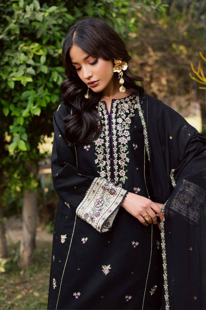 BATIK Night Bloom khaddar dress with intricate threadwork on sleeves and neckline, styled with traditional jewelry for a festive look.
