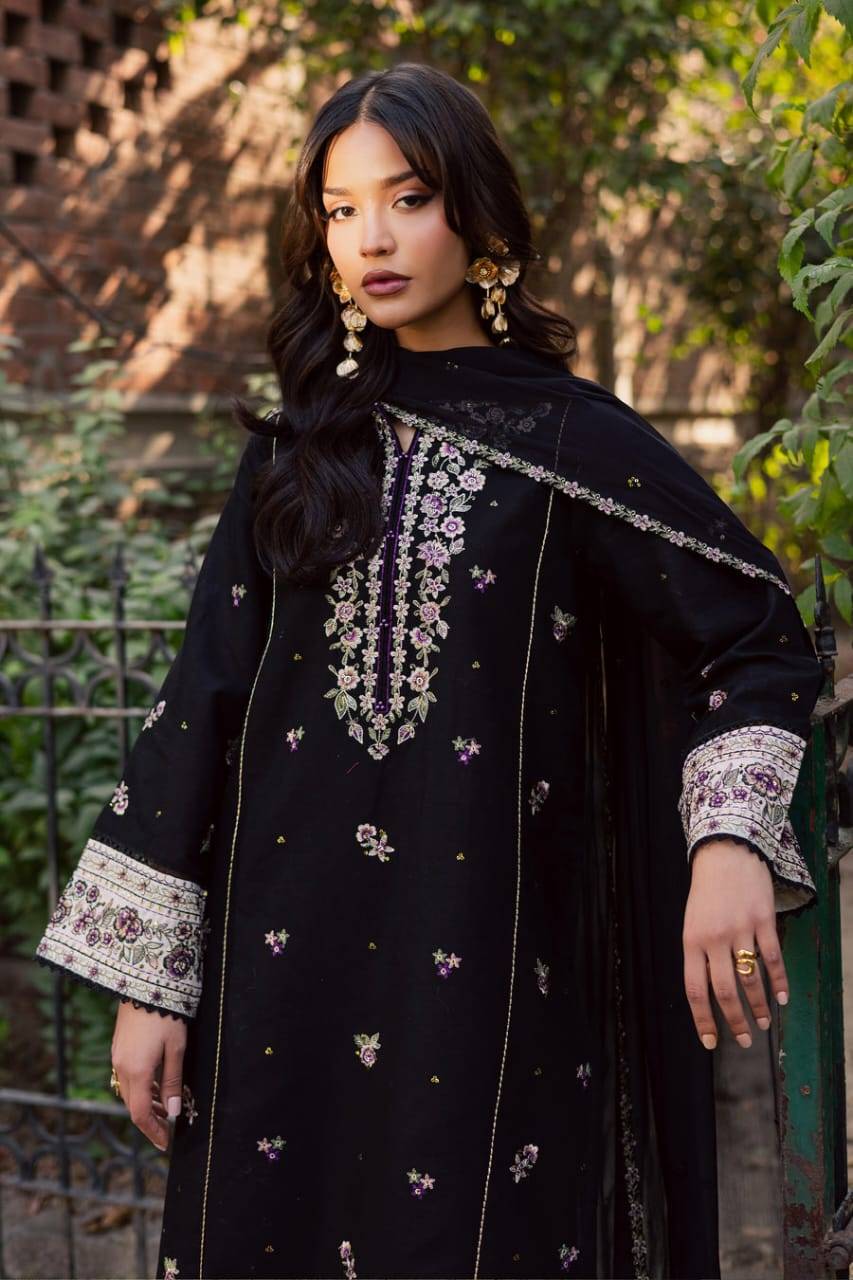 Elegant BATIK Night Bloom 3Pc outfit in black khaddar with floral embroidery and wide cuffs, styled with gold earrings for Pakistani fashion.