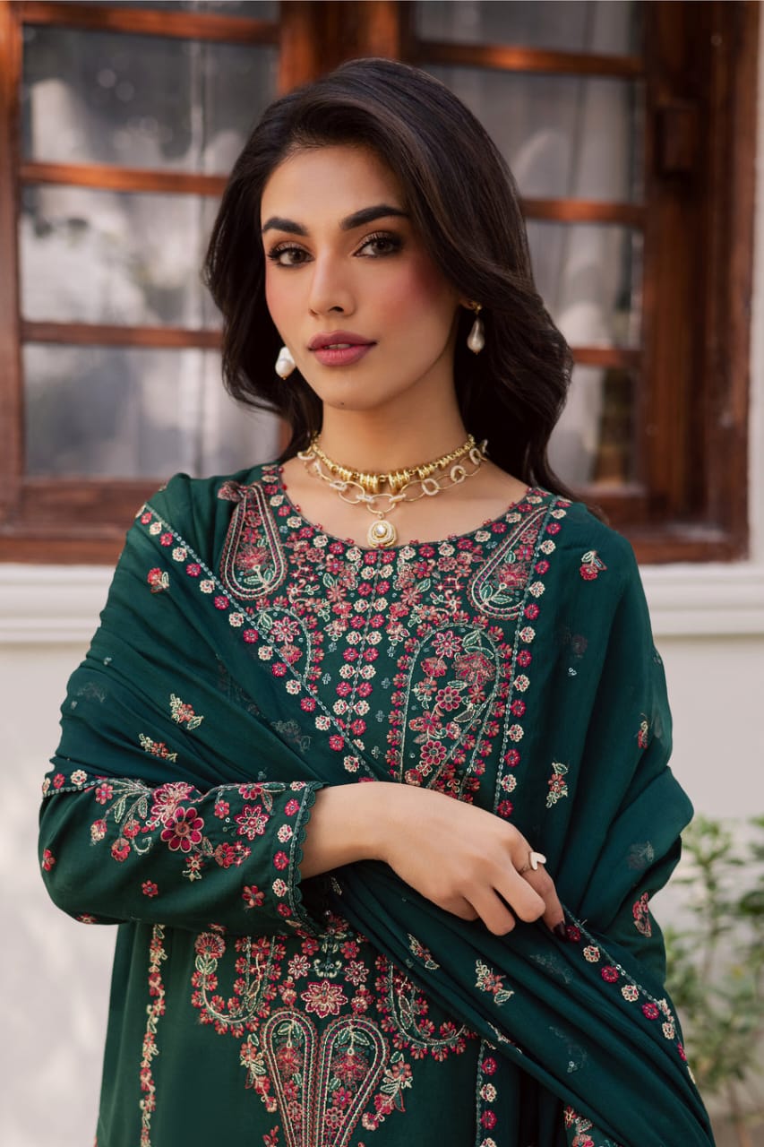 Model wearing BATIK Rain 3Pc embroidered khaddar dress with gold jewelry, highlighting neckline and sleeve embroidery for festive occasions.
