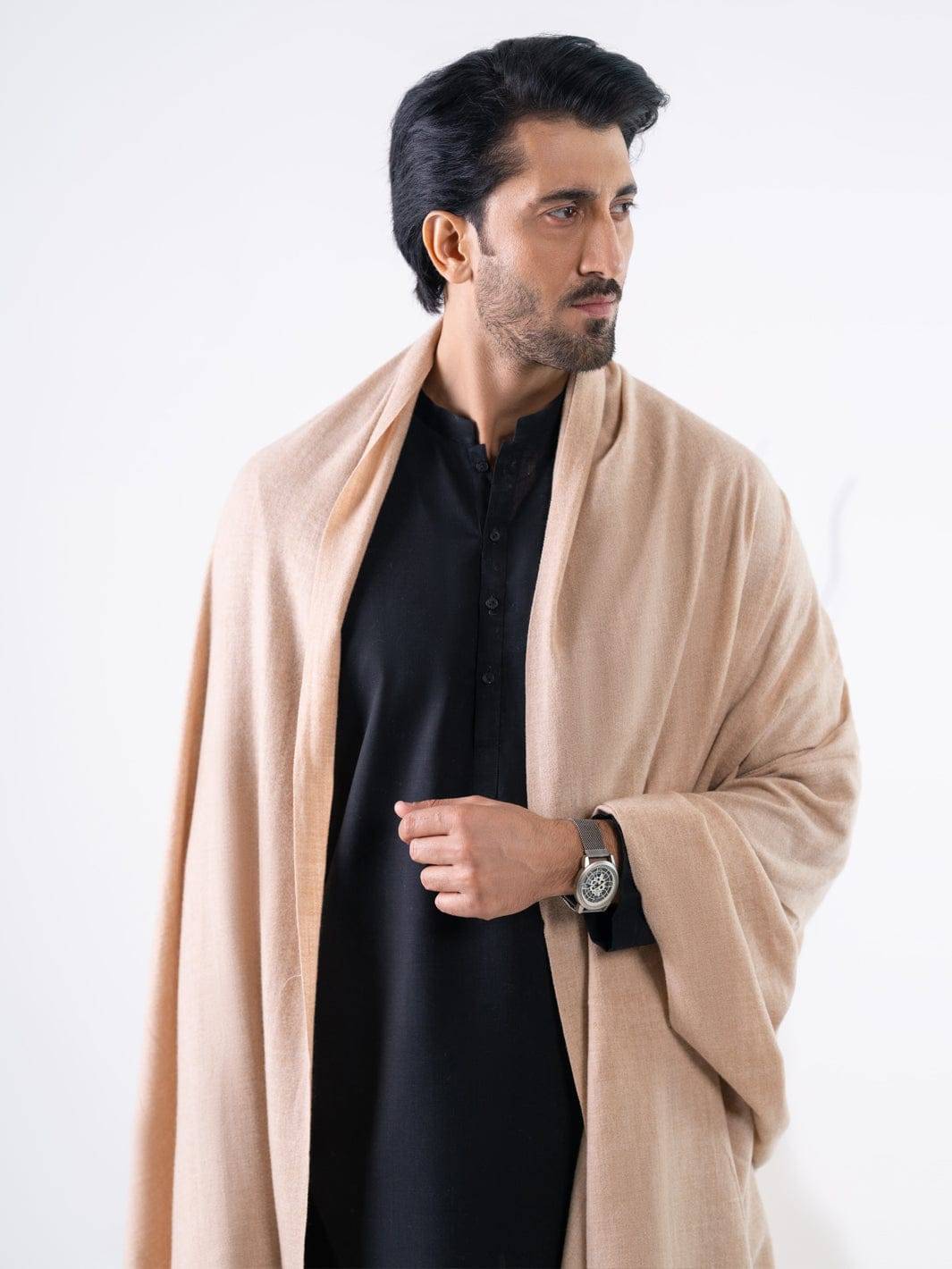 Close-up of ALMIRAH Beige Casual Shawl draped on man in black kurta. Elegant winter shawl from Pakistani collection for stylish casual wear.