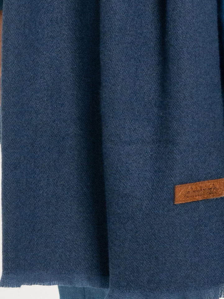 Detailed view of ALMIRAH Royal Blue Casual Shawl’s texture and stitched logo tag, ideal for men’s winter fashion.