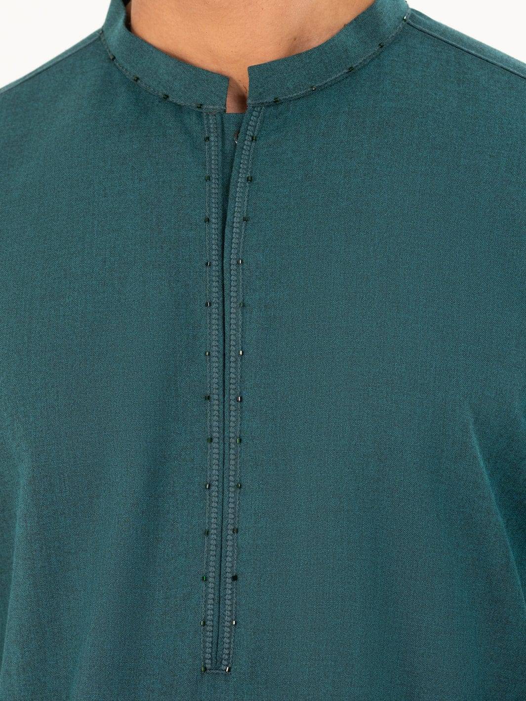 Detailed view of ALMIRAH green kameez front placket with fine stitching and bead accents, part of a 2-piece men’s winter outfit.