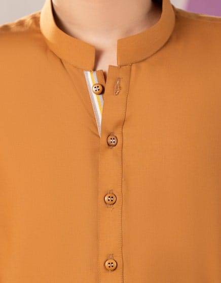 Close-up of Junaid Jamshed mustard kurta's button placket and collar, highlighting fine stitching and festive detailing for kids' ethnic wear.
