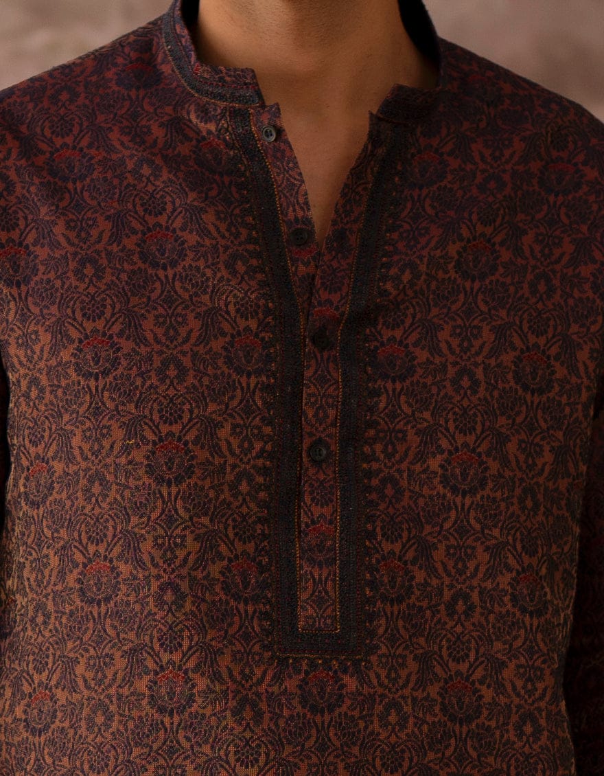 J. PEACH BLUE Buy Junaid Jamshed Boys Kurta |New Arrivals, zoomed-in view of the kurta's front placket and floral pattern on the blended fabric.