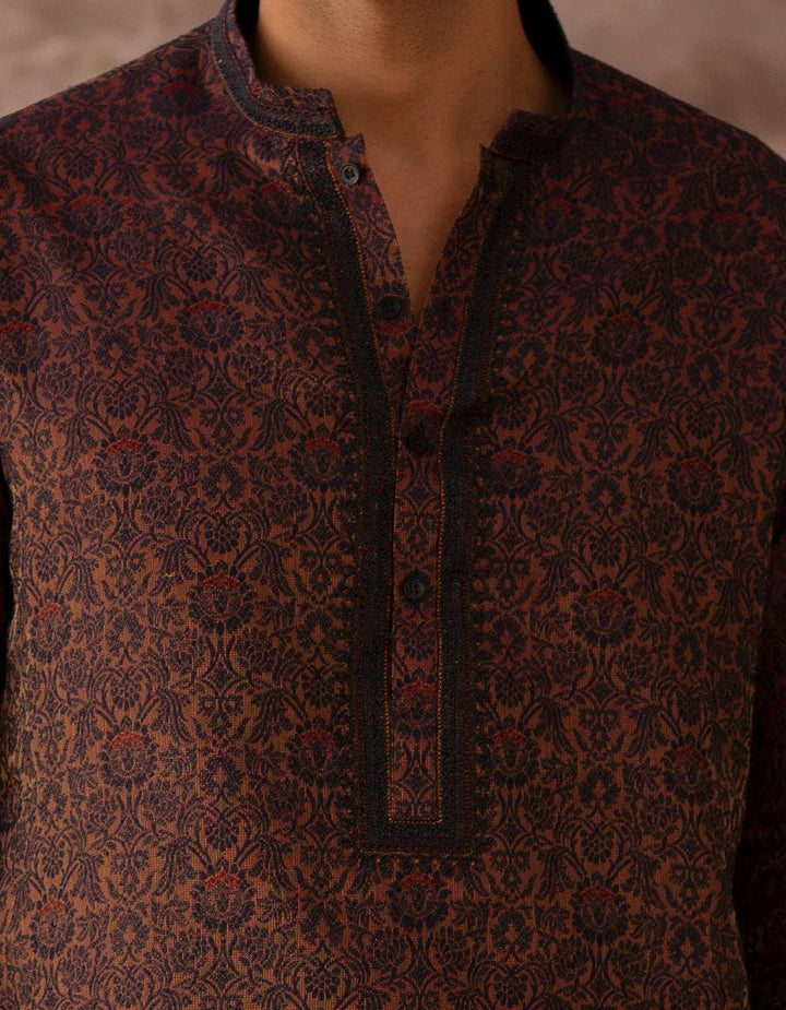 J. PEACH BLUE Buy Junaid Jamshed Boys Kurta |New Arrivals, zoomed-in view of the kurta's front placket and floral pattern on the blended fabric.