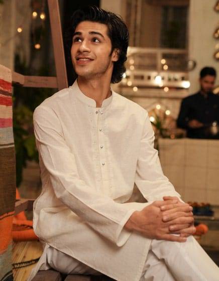 J. WHITE COTTON FORMAL KURTA - Buy J. Kurta Online | Cotton, Regular; seated model in white cotton kurta showcasing elegant festive wear.