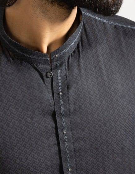 Detailed neckline of Junaid Jamshed black kurta with buttoned placket and fine stitching, part of the Monsoon Collection for men.