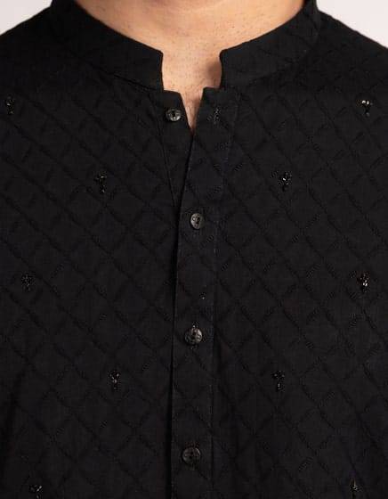Close-up of J. Black Kurta - Shop Junaid Jamshed Men Kurtas | Regular Fit showing textured cotton fabric with embroidered detailing and buttoned neckline.