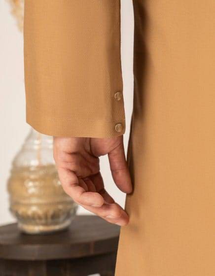 J. SEMI-FORMAL KURTA - Buy Junaid Jamshed Kurta in USA | Regular Fit close-up of cuff with button detail on beige cotton kurta, showcasing fine tailoring.