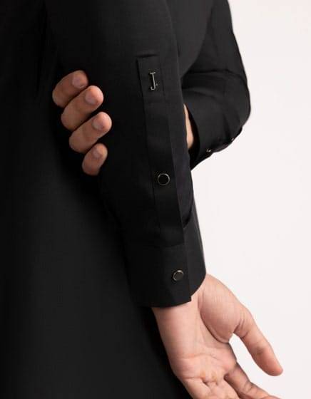 Detailed sleeve view of J. Black Casual Kameez Shalwar - Junaid Jamshed kurta with branded 'J.' tag and buttoned cuff design for a modern finish.
