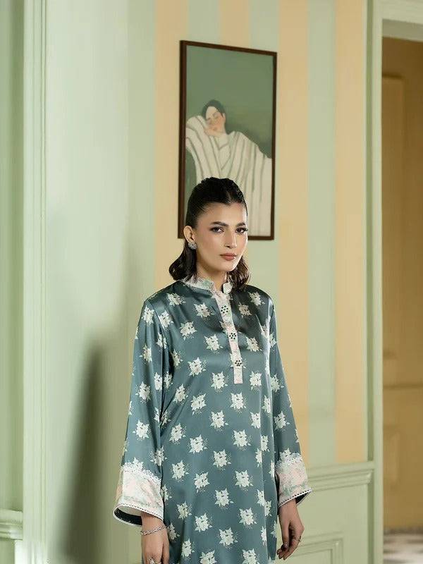 Close-up of woman in silk printed kurta with floral pattern and embroidered collar, showcasing elegant ethnic fashion.