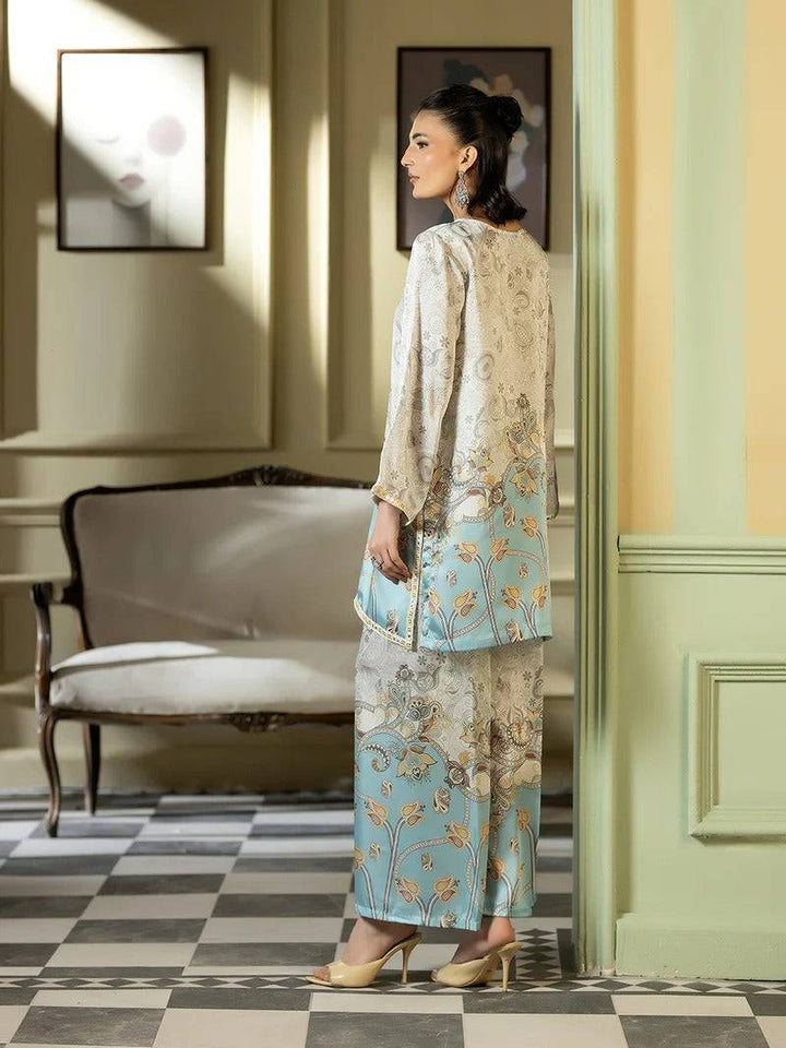 Side view of woman in silk embroidered outfit with artwork in background
