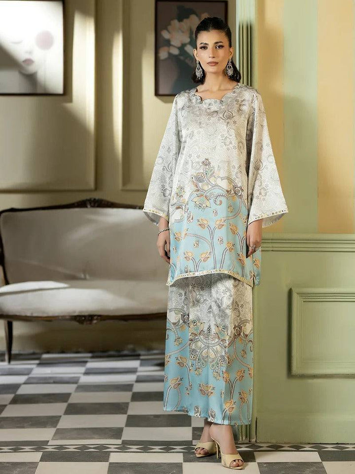 Full-length woman in silk printed outfit with floral design and heels