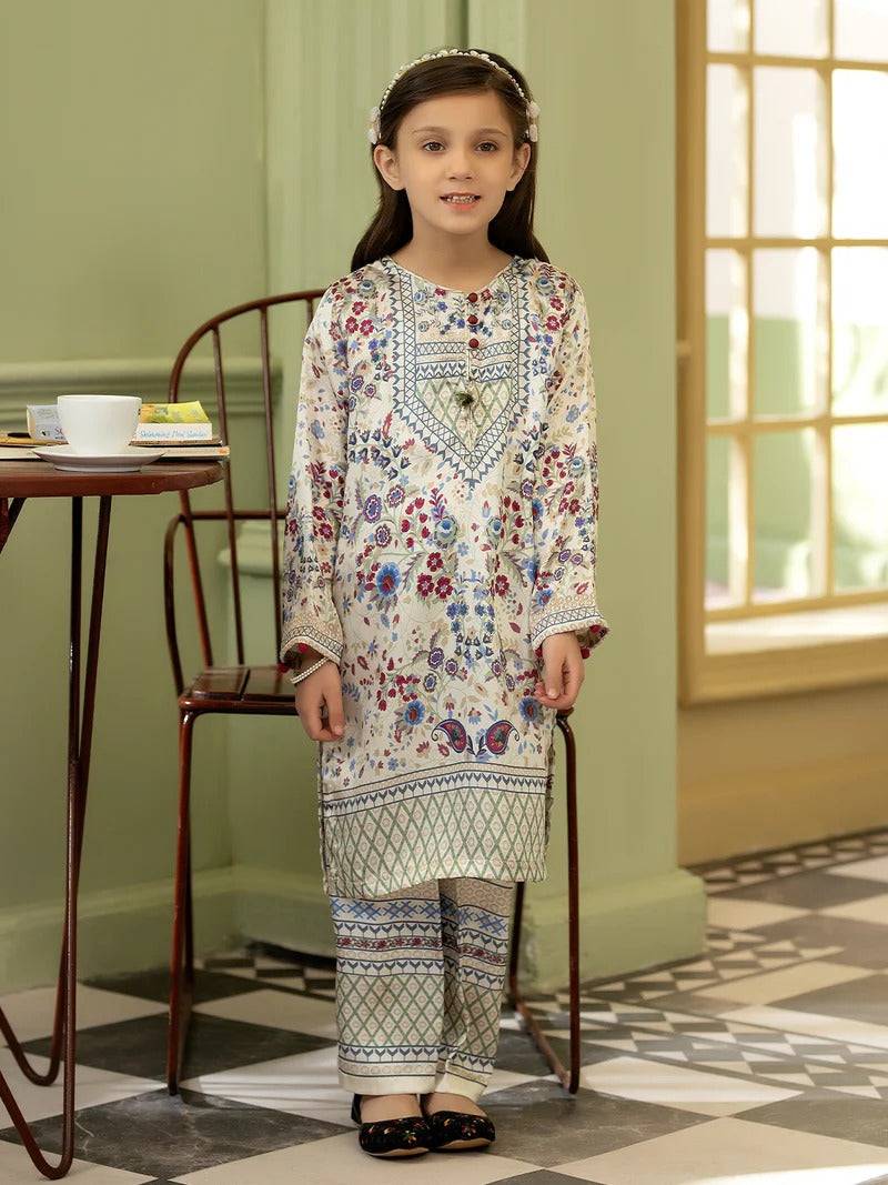 Girl wearing Rangreza Girl Silk 2 Piece traditional outfit with floral embroidery, standing indoors near a table with tea and snacks