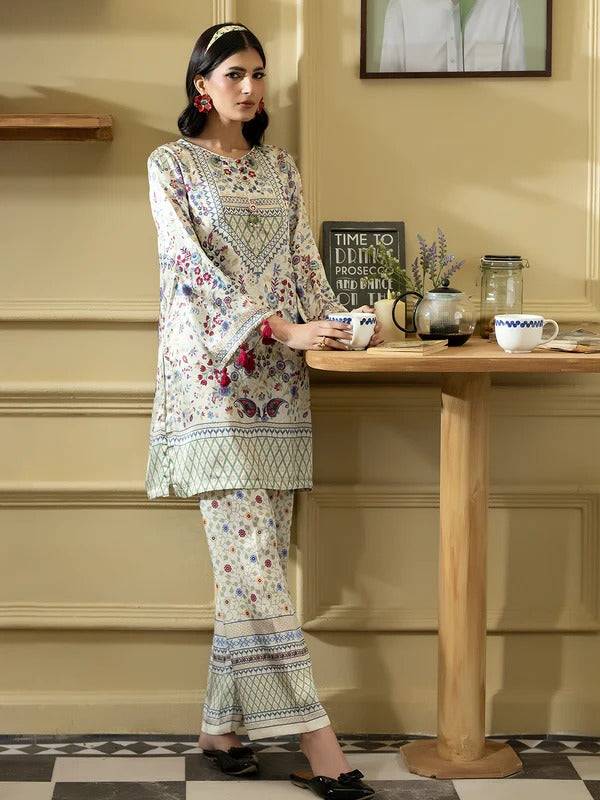 Women wearing Rangreza silk 2-piece outfit with printed top and matching trousers in a cozy indoor setting