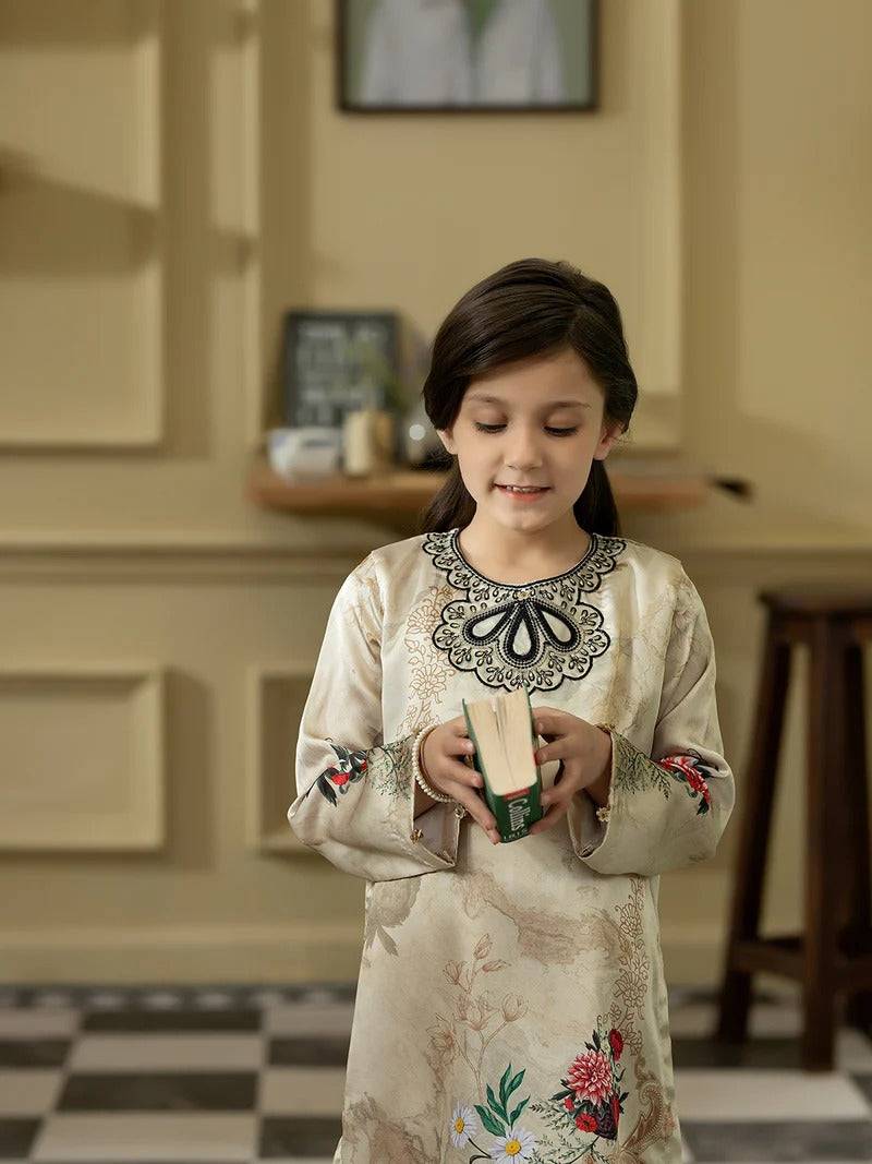 Front view of girl in silk embroidered kurta holding a book