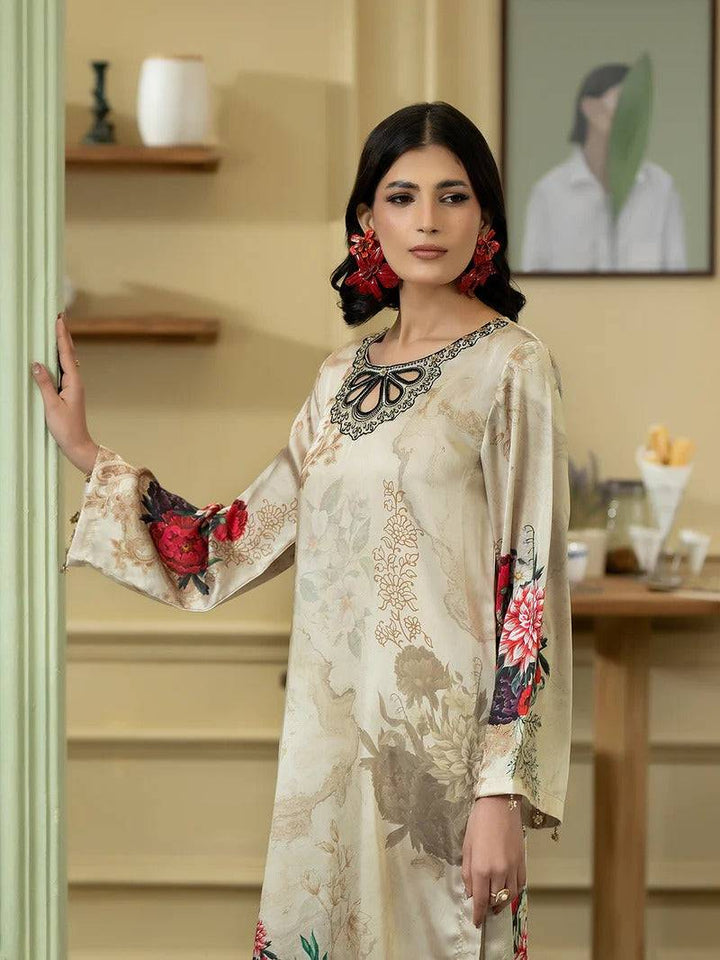 Close-up of woman in Rangreza silk 2-piece with floral sleeve design and beige background