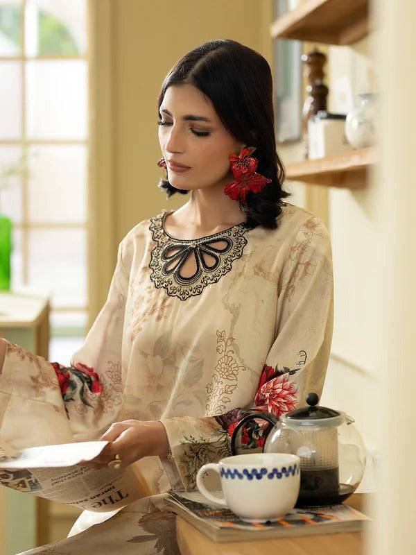 Woman in Rangreza silk 2-piece with floral embroidery, drinking coffee at home