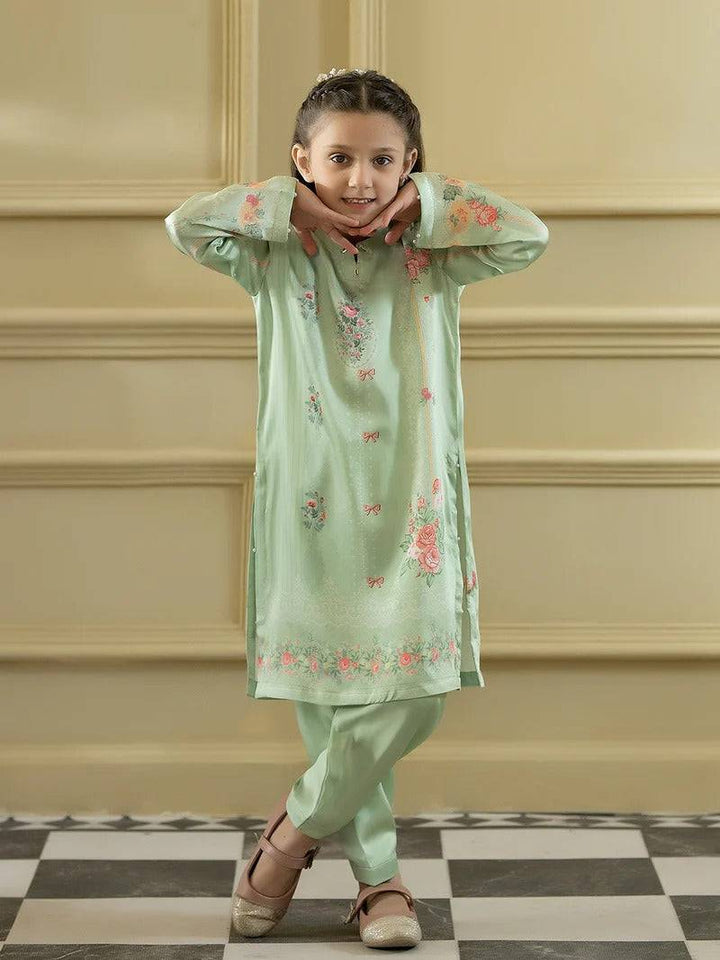 Girl wearing green silk kurta with floral embroidery and matching trousers, traditional apparel for girls