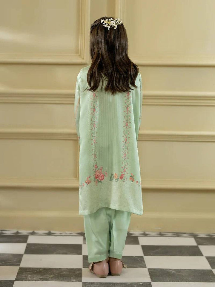 Back view of girl in green silk kurta with floral embroidery and matching trousers, traditional girl’s clothing